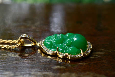 Jewelry is jade. Gold necklace decorated with green jade.の写真素材