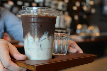 Close-up shot, hand holdingfood and coffee drink