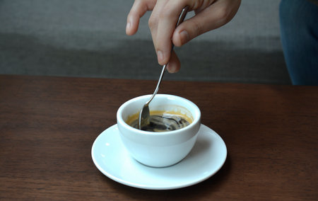 Close-up shot, hand holdingfood and coffee drinkの写真素材