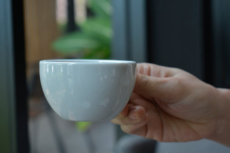 Close-up shot, hand holdingfood and coffee drinkの写真素材