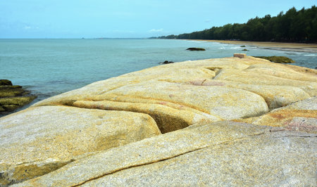 On the beach there are rocks, large boulders and sea sand andの写真素材