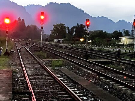 Railway track in evning with red light.