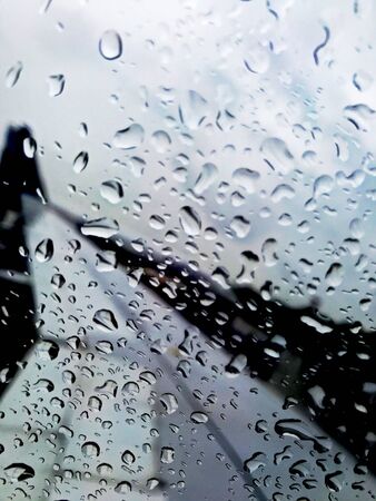 close up of water drops in flight windowの写真素材