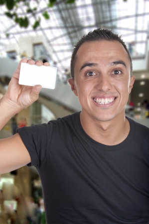 Young Man with credit card in a shopping centerの写真素材
