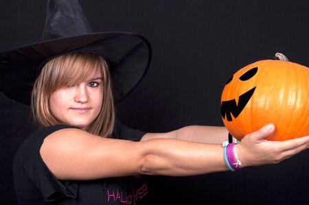 Toddler beautiful witch girl wearing halloween costume and make up の写真素材