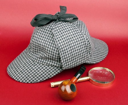 Detective Sherlock Holmes kit on red backgroundの写真素材