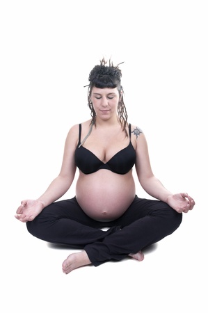 portrait of beautiful pregnant woman doing yoga . isolated on white background の写真素材