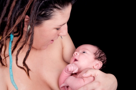 mother with newborn on black backgroundの写真素材