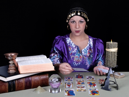 Gypsy fortune teller holding a tarot card の写真素材