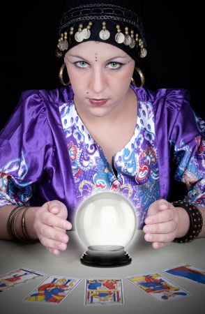 Gypsy fortuneteller uses a crystal ball to foretell the future の写真素材