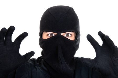 Burglar attack against white background の写真素材