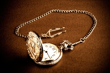Old retro pocket watch with chain on table の写真素材