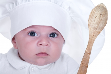 cute little baby dressed as a cook の写真素材
