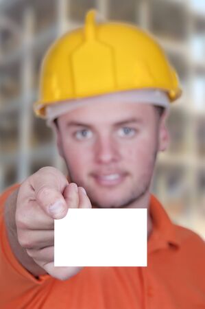 portrait of  engineer man holding blank business card の写真素材