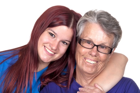 Happy affectionate senior woman embrace her granddaughter at home 