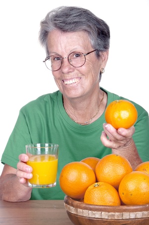 Mature smiling woman with orange juice の写真素材
