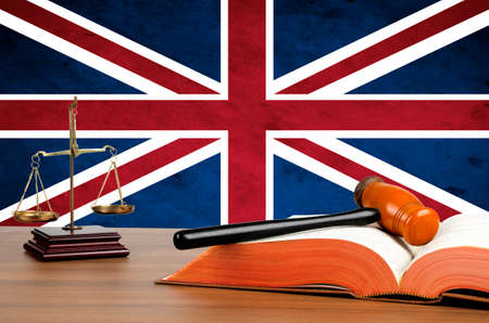 Mallet, legal code and scales of justice with the United Kingdom union jack flag behind. の写真素材