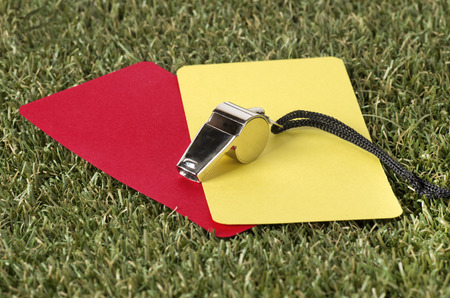 Close-up Of Whistle With Red And Yellow Card On The Fieldの写真素材
