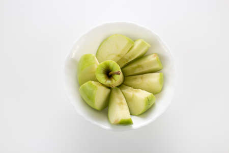 apples in small white bowlの写真素材