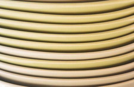 Smiling dishes.Close-up of a stack of yellow dishes.の写真素材