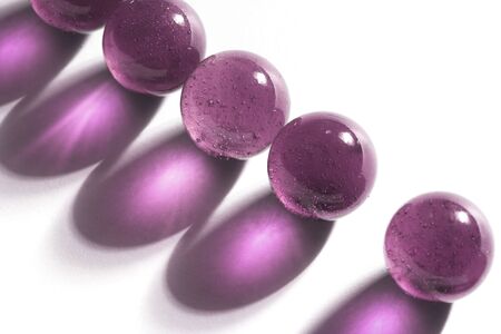 Purple marbles on white background, colored shadow.の写真素材