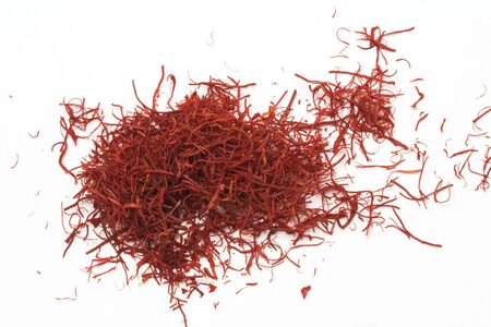 A pile of red saffron on a white background.