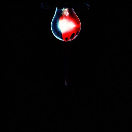 Old messy bulb covered with blood, isolated on black.の写真素材