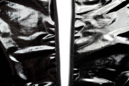Two sides of black vinyl jacket unzipped.の写真素材