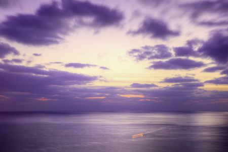 Purple dusk sea and a ship trace. Long exposure.