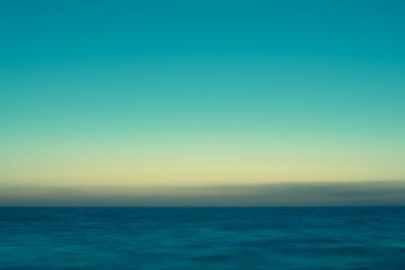 Long exposure shot of calm and misty sea early in the morning.の写真素材