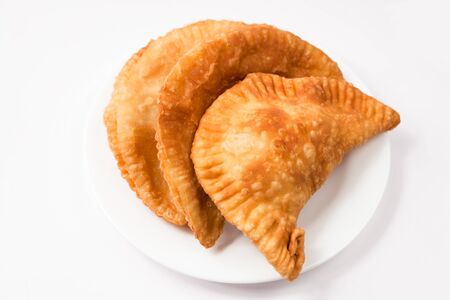 Cheese empanada, meat empanada or chicken empanada on a white plate. Empanada (meat pie) - traditional snack originally from Spain.の写真素材