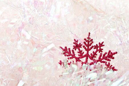 Reg glitter snowflake sitting in pink tinsel.の写真素材