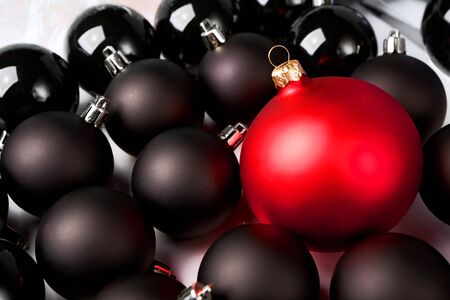 Black Christmas baubles with one red in the group.の写真素材