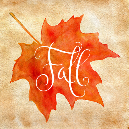 Orange watercolor autumn maple leaf and handwritten word Fall over vintage brown paper.の写真素材