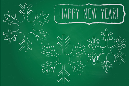 Three chalk snowflakes and a frame with New Year greetings over green chalkboard.のイラスト素材