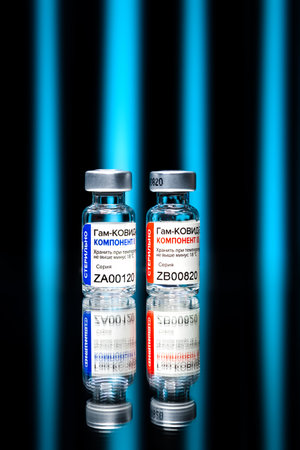 MOSCOW, RUSSIA - February 9, 2021: New Russian vaccine Sputnik V over blue glowing stripes background.のeditorial素材