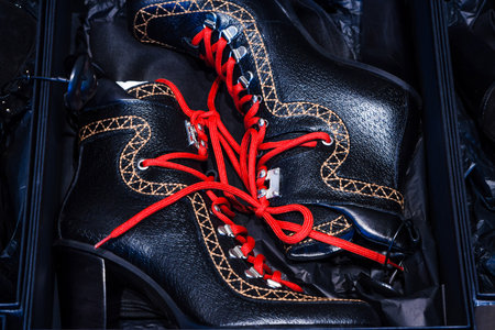 Brand new shoes in the black box. Bright red laces.の写真素材