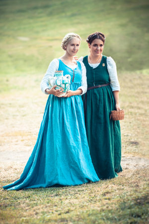 MOSCOW, RUSSIA - JUNE 23, 2013: Two medieval girls in traditional  period dresses during the great international yearly festival of historical reconstruction "Times and Epochs"のeditorial素材