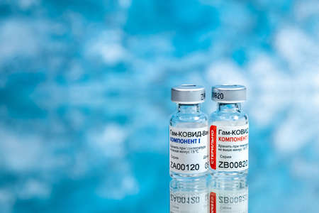 MOSCOW, RUSSIA - February 9, 2021: New Russian Coronavirus vaccine Sputnik V over blue background. Covid-19, 2019-nCov pandemic concept.のeditorial素材