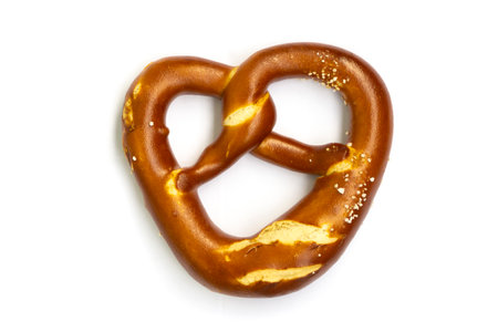 Traditional German pretzel, delicious and iconic snack perfect for Oktoberfest, pub or street food. Salty baked treat with golden brown crust, isolated on a white backgroundの写真素材