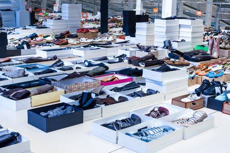 Big clothes outlet, luxury and fashionable interior of garments store. Shoes department.のeditorial素材