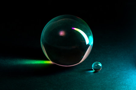A captivating arrangement of glass spheres reflecting vibrant colorful lights, showing elegance and modernity in artistic design.の写真素材
