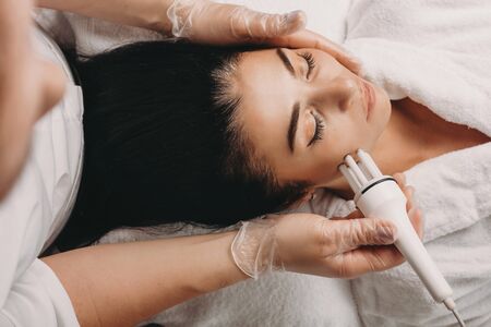 Caucasian brunette having a skin care procedure while lying on couch at a spa salon
