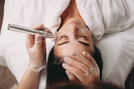 Caucasian woman having an anti aging procedure with modern apparatus during a spa sessionの写真素材