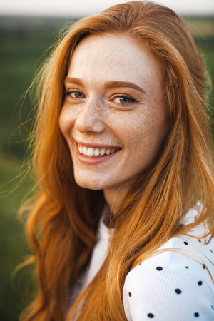 Beautiful red haired woman with freckles. Pretty young woman. Luxury travel. Beauty face.の写真素材