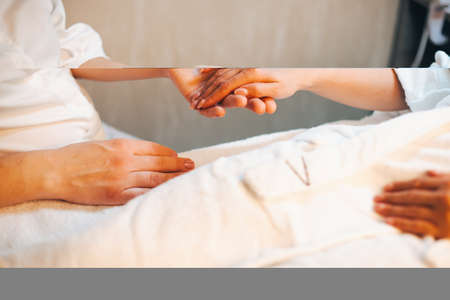 Hand massage. Physiotherapist holding the clients hand. Doctor hand. Beauty treatment. Skin care.の写真素材