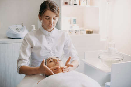 Woman getting spa massage treatment at beauty spa salon. Facial beauty treatment. Cosmetology.