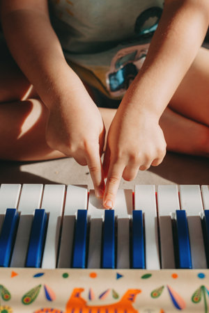 Close up portrait of hands of a child playing the piano. Children play music. Index fingersの写真素材