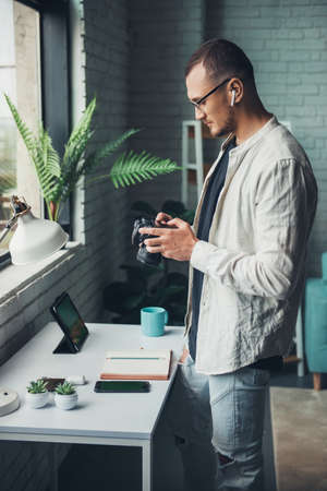 Male photographer shooting study objects placed on the table. Modern lifestyle. Studio photography....