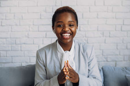Afro woman influencer recording video talking and gesturing at camera. E learning concept.の写真素材